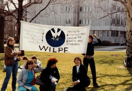 Group on lawn with Women's International League for Peace and Freedom banner