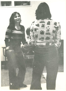 Two women talking wearing boxing gloves during self defence class at the Amazon Self-Defence and ...