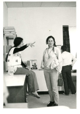Amazon Print Shop interior view with Lynn Kirk sitting and pointing with woman standing looking a...