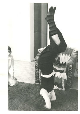 Lise Vaugeois, Trinette and Monique De Wyck doing yoga with one woman doing headstand